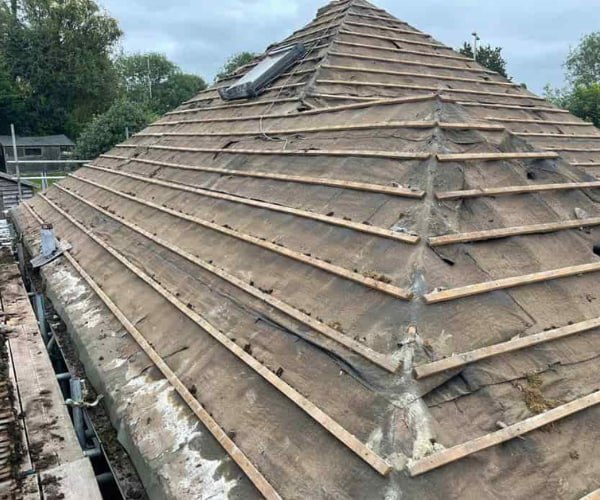 This is a photo of a hip roof that has been stripped back to the battens, and is awaiting a new roof covering to be installed. Works carried out by FDC Roofing Finedon